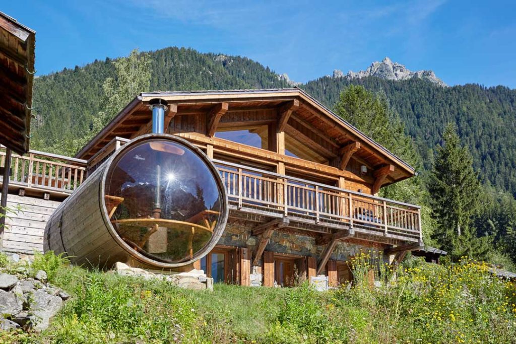 Eco lodge ski chalet exterior with outdoor sauna and mountain views in Chamonix